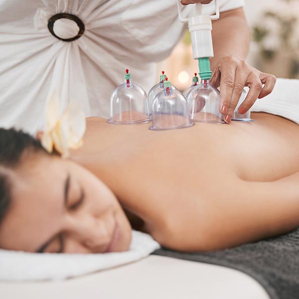 Doctor stretching out man's right arm during sports massage