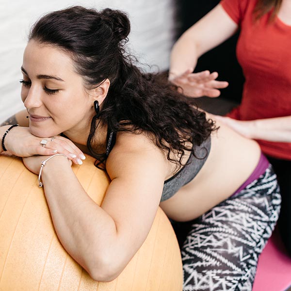 Doctor stretching out man's right arm during sports massage