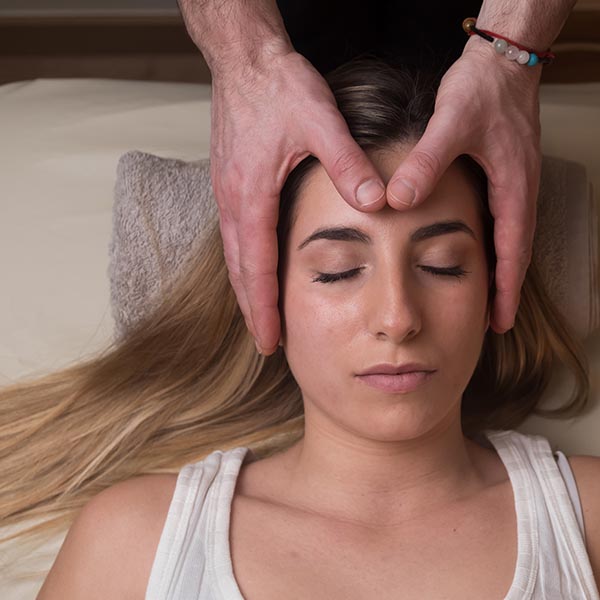 Doctor stretching out man's right arm during sports massage